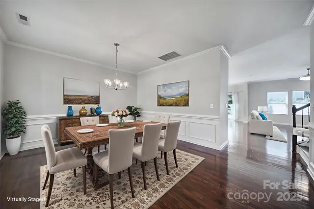 a view of a dining room with furniture wooden floor and a chandelier