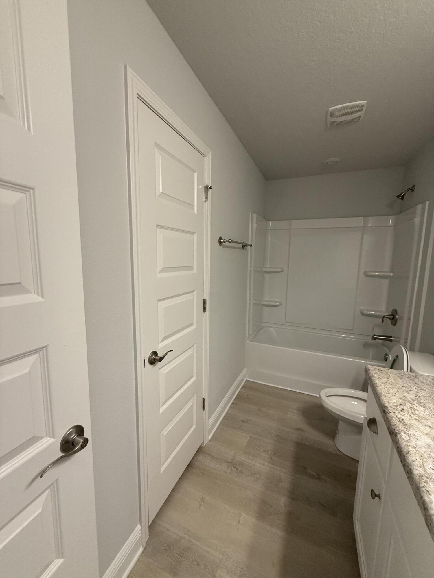 6002 Crocket Cove Crestview, FL 32539 - Photo 11 of 29 a bathroom with a granite countertop sink and a mirror
