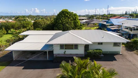 a aerial view of a house with swimming pool next to a yard