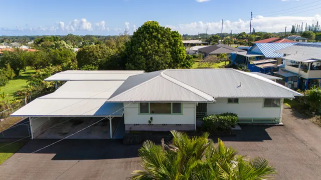a aerial view of a house with swimming pool next to a yard