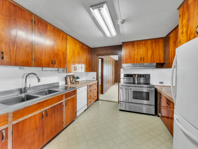 a kitchen with stainless steel appliances a stove sink and refrigerator