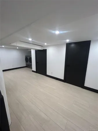 an empty room with wooden floor and entryway