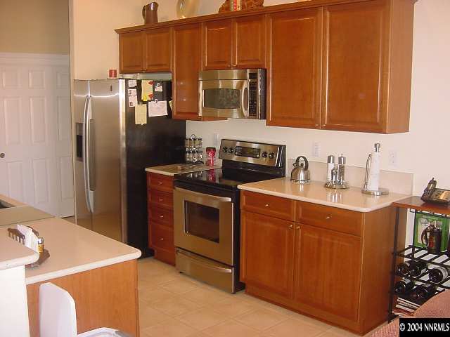 1743 Big Boulder Court Reno, NV 89521 - Photo 2 of 5 a kitchen with stainless steel appliances granite countertop a refrigerator stove and sink