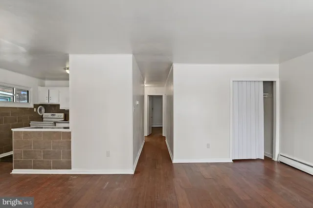 a view of a kitchen with a sink and a refrigerator