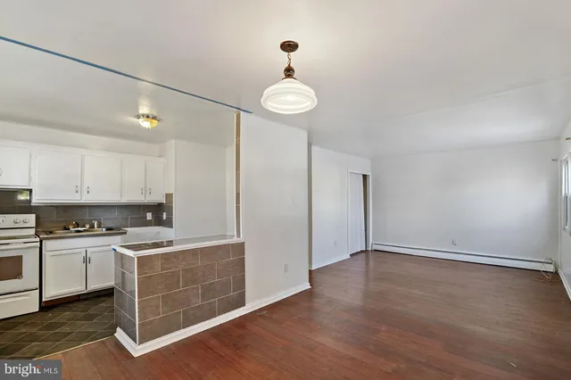 a view of a kitchen with a sink dishwasher and wooden floor