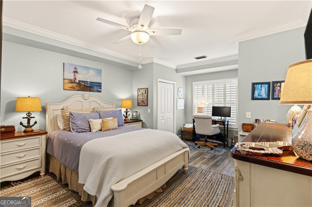 1035 Beach View Drive, Unit 201 St. Simons, GA 31522 - Photo 12 of 18 a bedroom with a bed and wooden floor