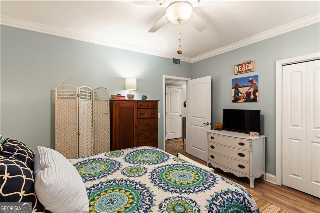 1035 Beach View Drive, Unit 201 St. Simons, GA 31522 - Photo 16 of 18 a bedroom with a bed and a flat screen tv