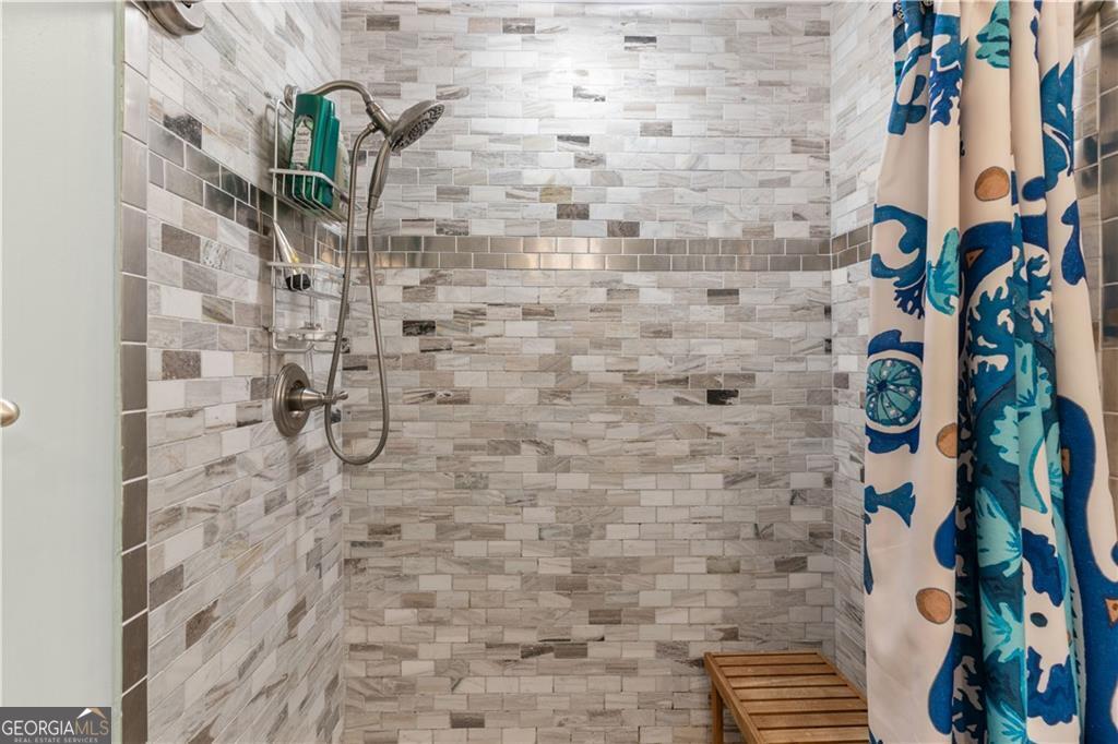 1035 Beach View Drive, Unit 201 St. Simons, GA 31522 - Photo 18 of 18 a bathroom with a shower and a plant