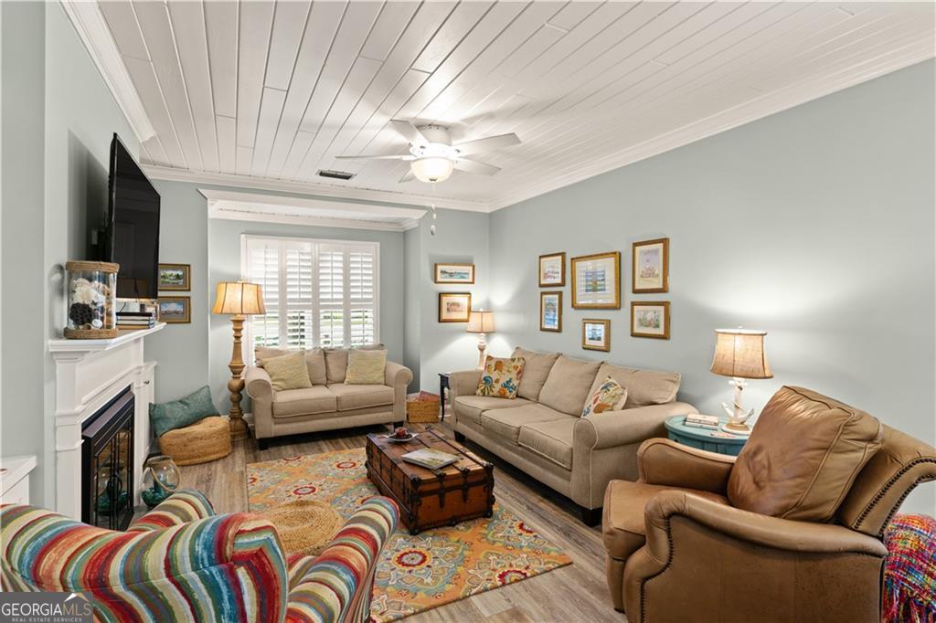 1035 Beach View Drive, Unit 201 St. Simons, GA 31522 - Photo 10 of 18 a living room with furniture fireplace and a flat screen tv