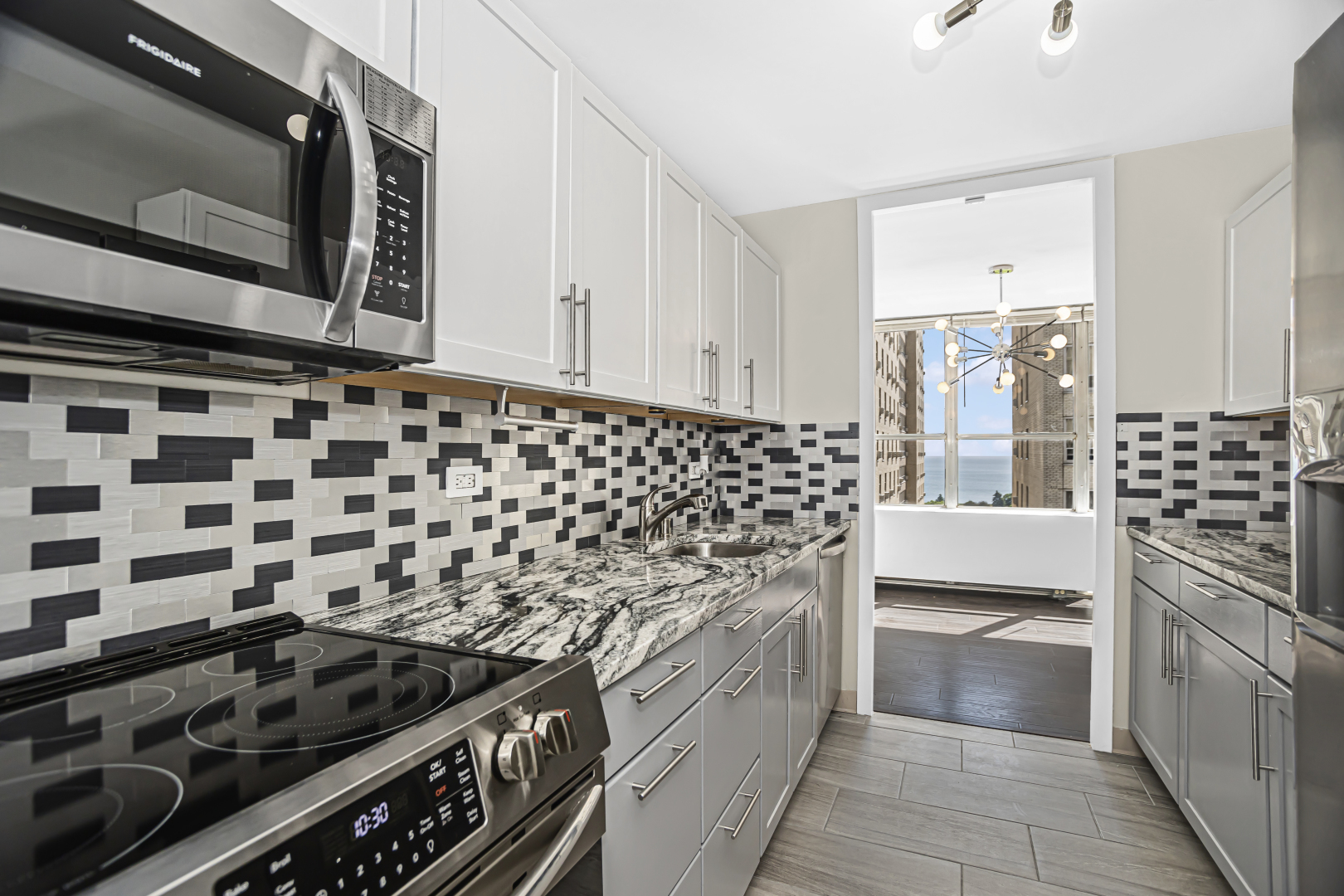 655 West Irving Park Road, Unit 1201 Chicago, IL 60613 - Photo 12 of 25 a kitchen with a stove and a microwave
