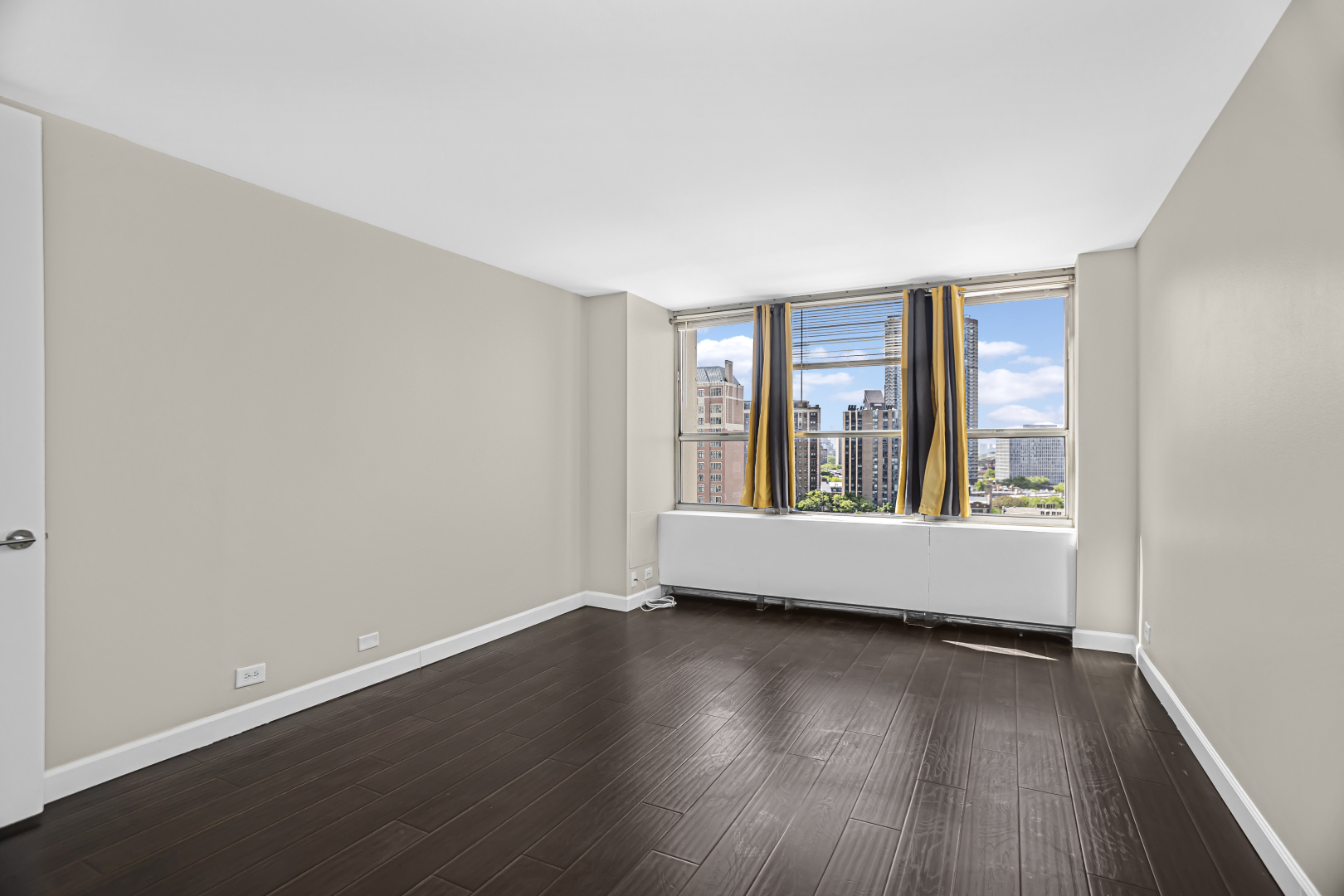 655 West Irving Park Road, Unit 1201 Chicago, IL 60613 - Photo 14 of 25 an empty room with wooden floor and windows