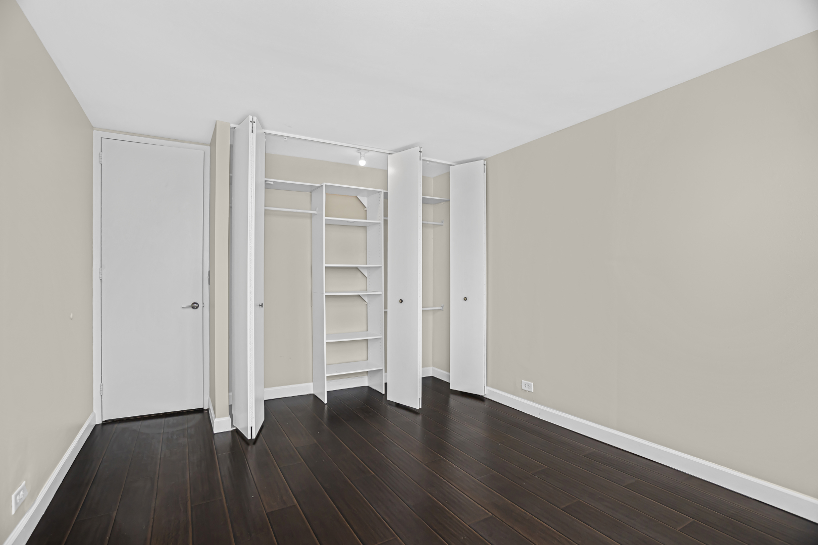 655 West Irving Park Road, Unit 1201 Chicago, IL 60613 - Photo 16 of 25 a view of an empty room with wooden floor and closet