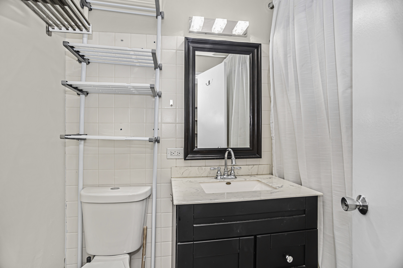 655 West Irving Park Road, Unit 1201 Chicago, IL 60613 - Photo 18 of 25 a bathroom with a sink a toilet and shower