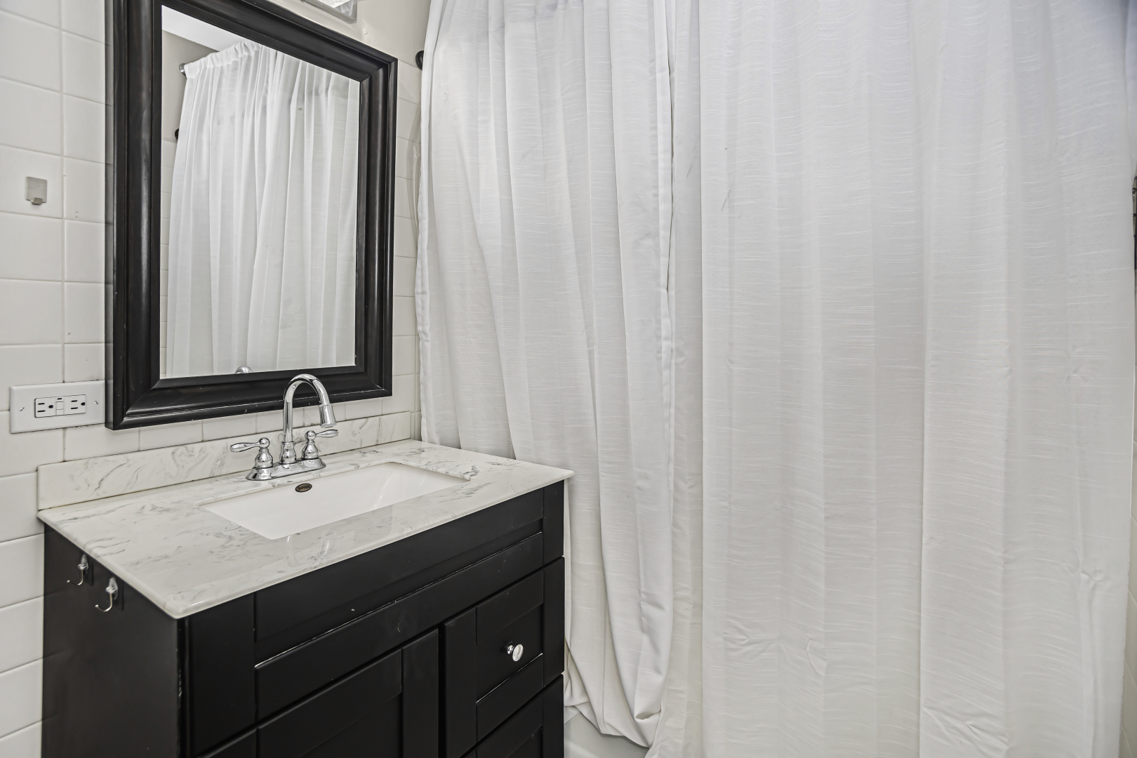 655 West Irving Park Road, Unit 1201 Chicago, IL 60613 - Photo 19 of 25 a bathroom with a sink and a mirror