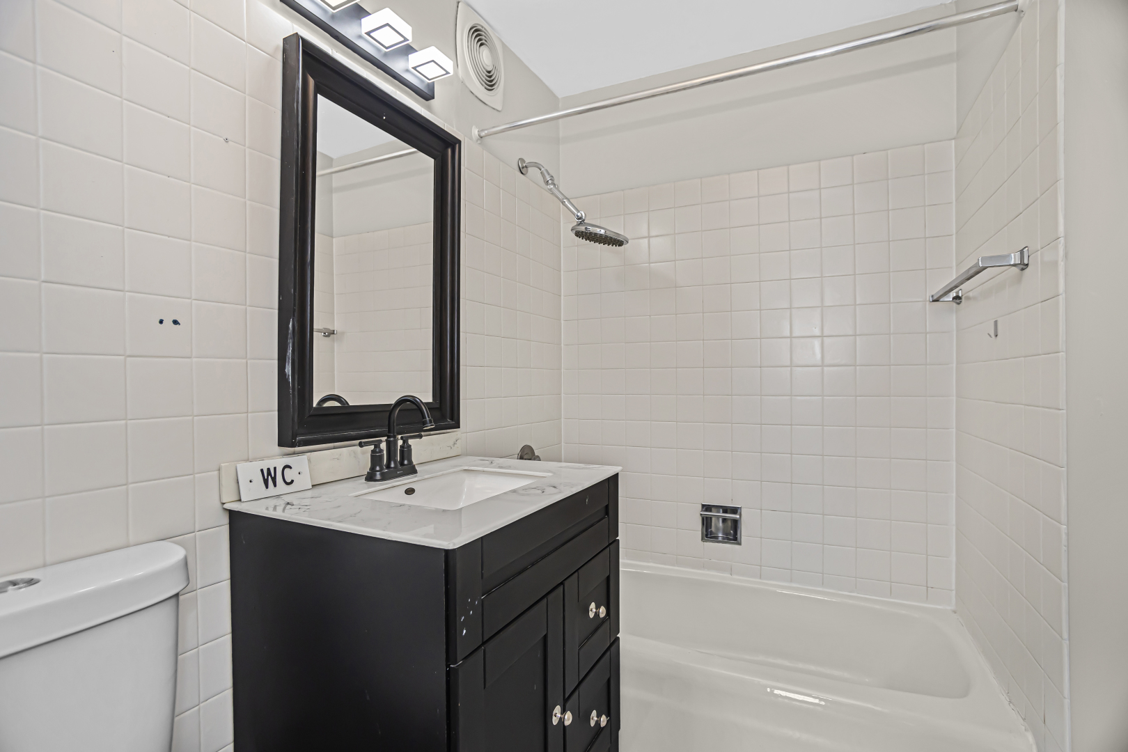 655 West Irving Park Road, Unit 1201 Chicago, IL 60613 - Photo 20 of 25 a bathroom with a sink and a mirror