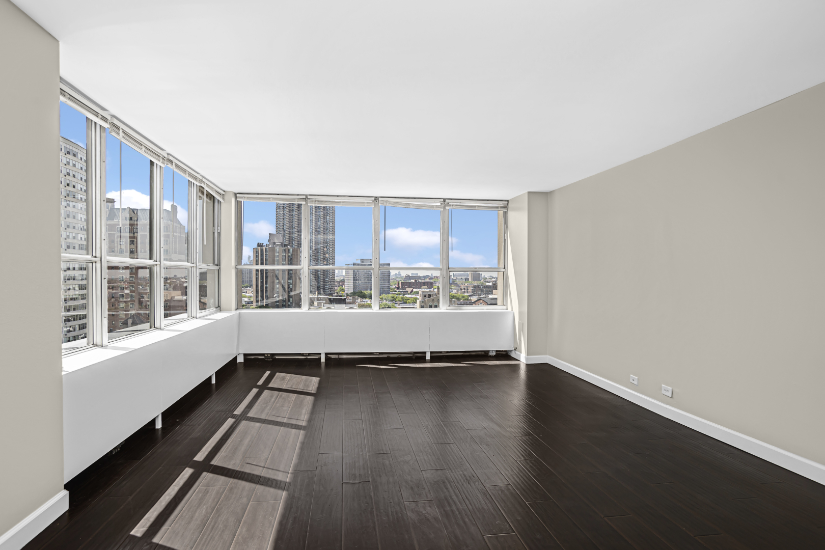 655 West Irving Park Road, Unit 1201 Chicago, IL 60613 - Photo 8 of 25 a view of a large room with wooden floor and windows