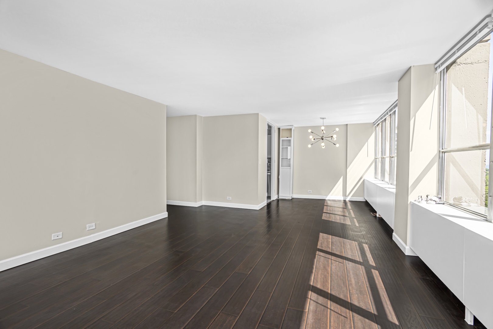 655 West Irving Park Road, Unit 1201 Chicago, IL 60613 - Photo 10 of 25 an empty room with wooden floor and windows