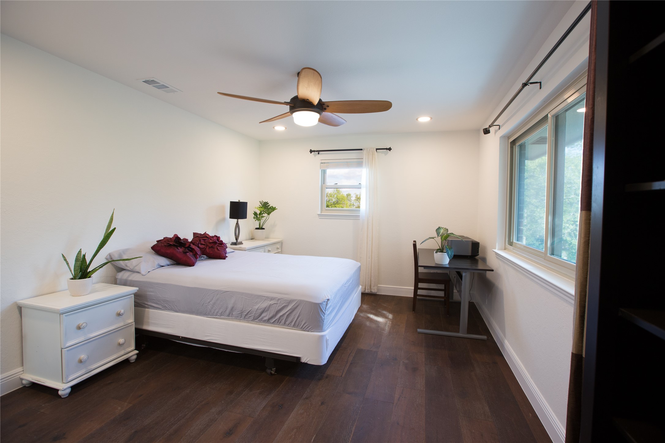 3517 Gattis School Road Round Rock, TX 78664 - Photo 6 of 16 Rich hardwood floors complement a well-lit bedroom featuring a classic ceiling fan for ultimate comfort.