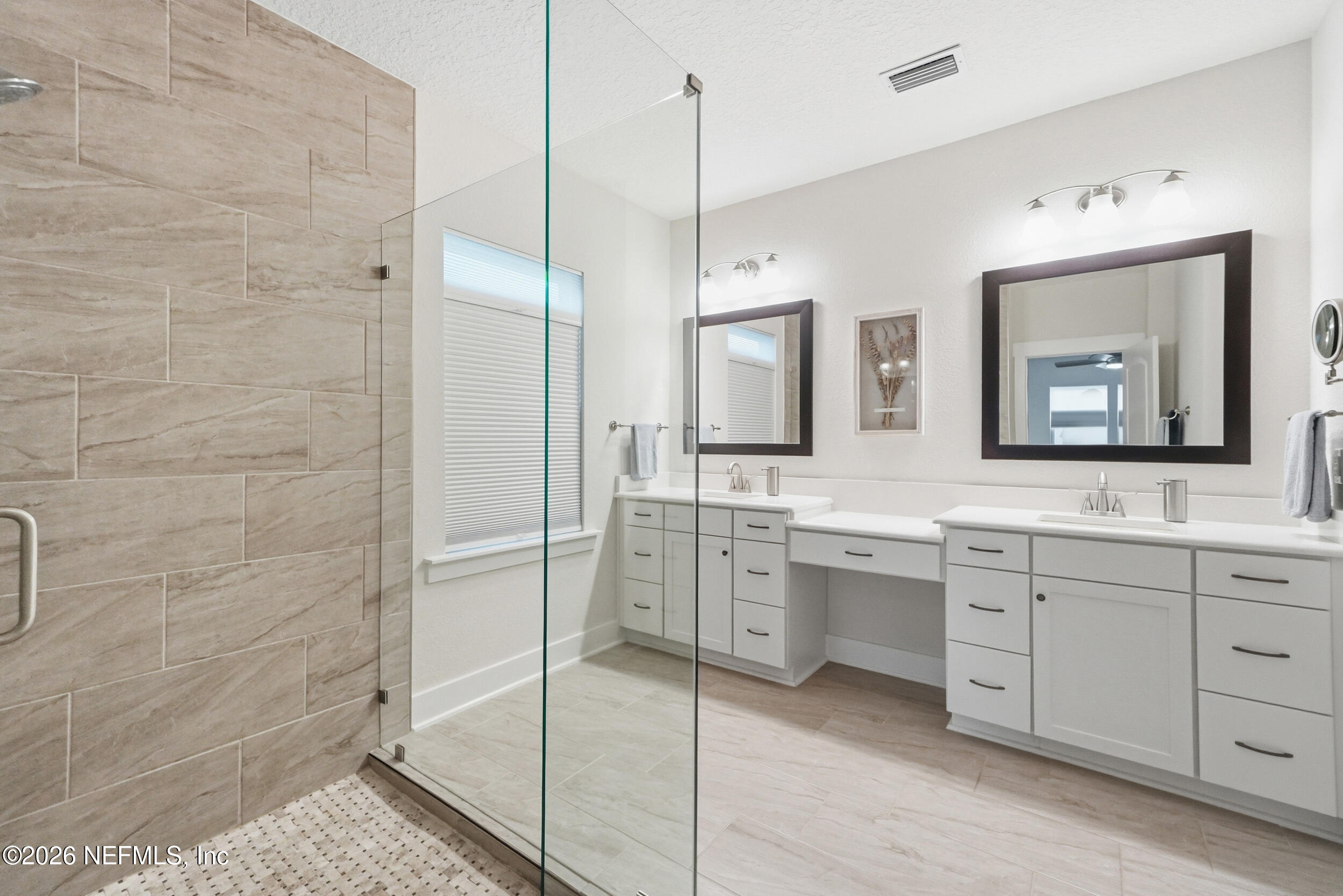 34 Red Rock Lane St. Johns, FL 32259 - Photo 26 of 71 a bathroom with a double vanity sink a mirror and a shower