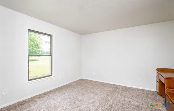 a view of a big room with wooden floor and closet