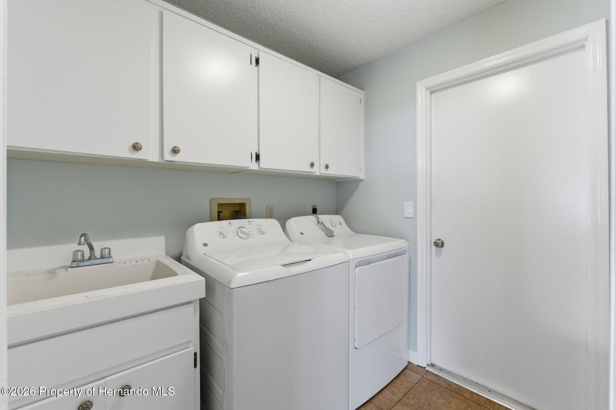 4966 Keysville Avenue Spring Hill, FL 34608 - Photo 31 of 50 a utility room with dryer and washer