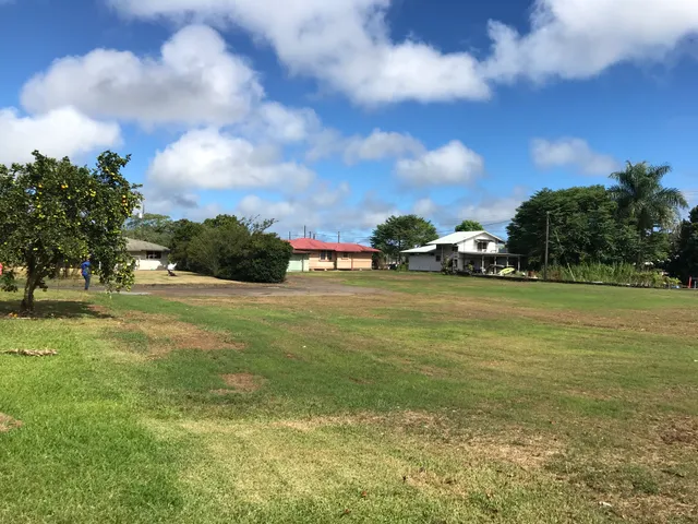 a view of yard with swimming pool and green space
