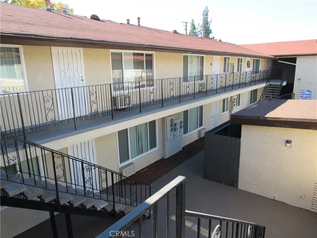 a view of a house with wooden deck and a ocean view