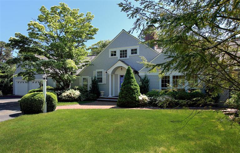 a front view of a house with a garden