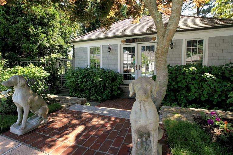 9 North Bay Road Osterville, MA 02655 - Photo 24 of 25 a view of a white house with many windows and plants