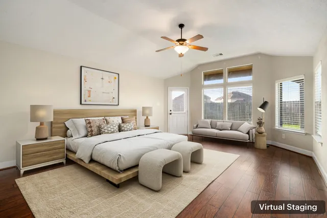 a bedroom with a bed couch and a window