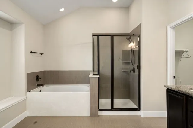 a bathroom with a bathtub and a shower