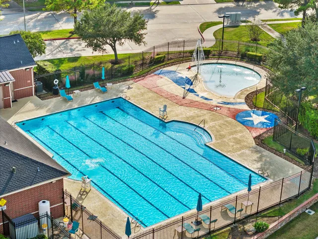 a view of a house with pool and chairs