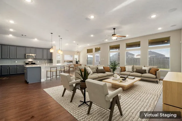 a living room with lots of furniture and kitchen view