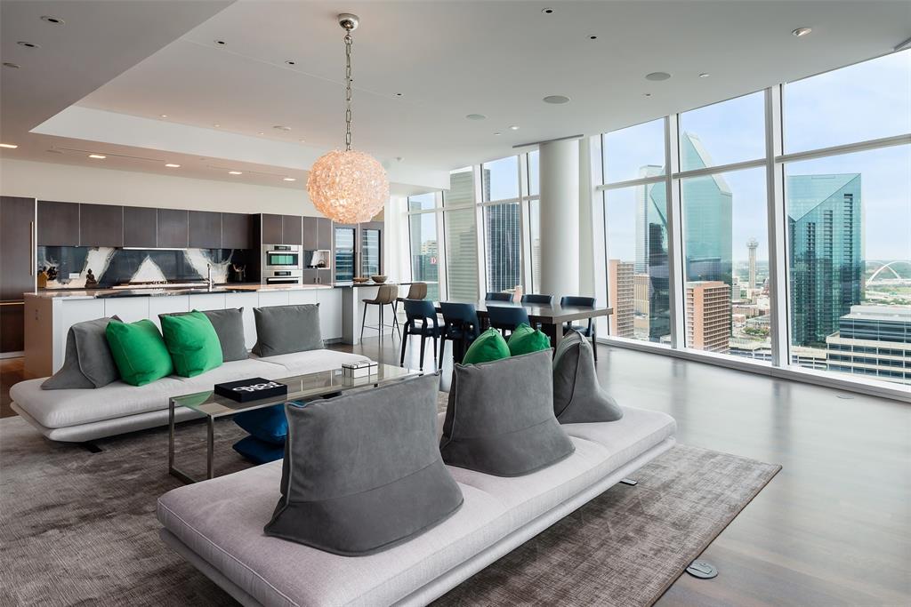 a dining room with furniture a chandelier and wooden floor