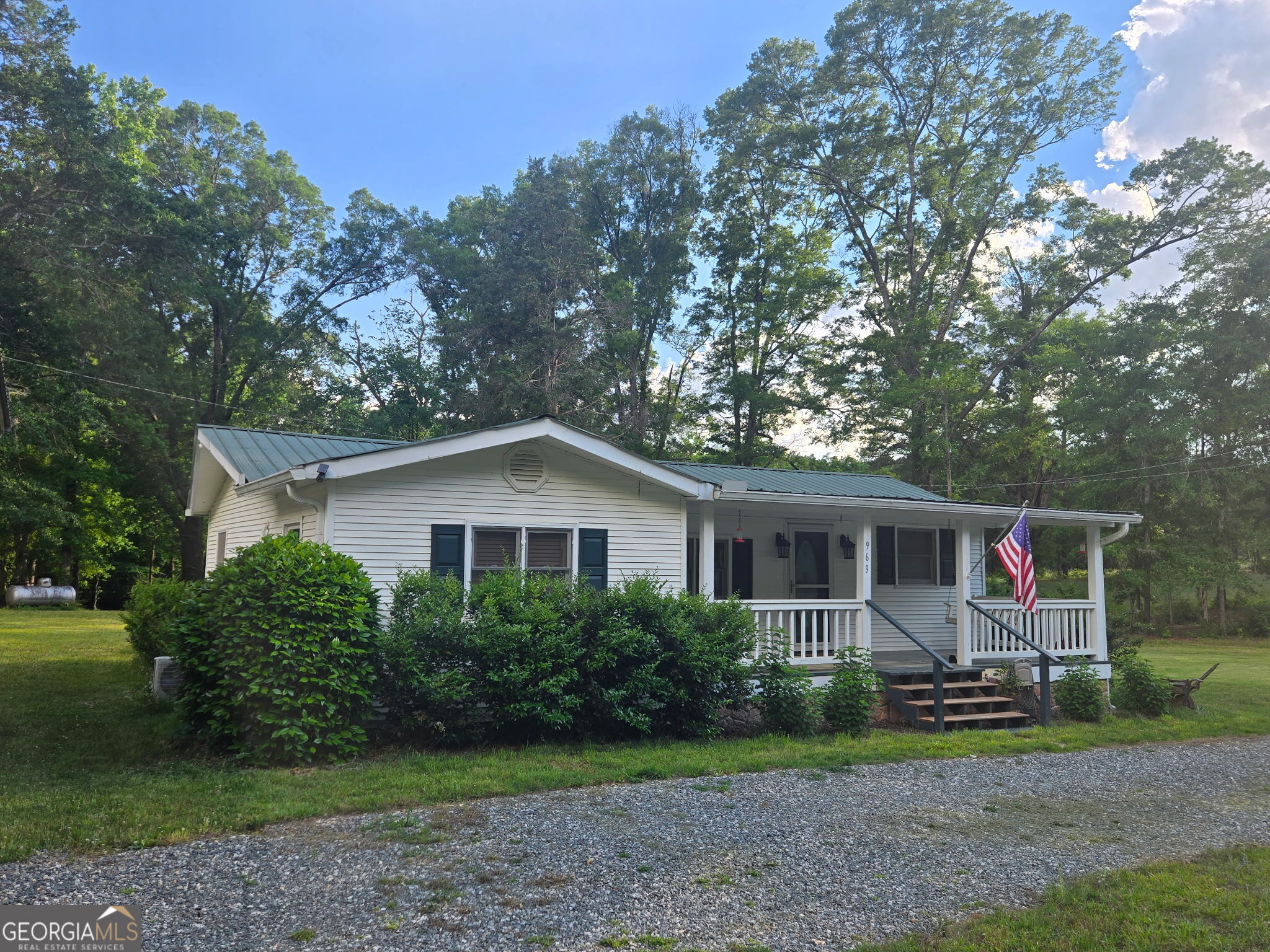 969 Flowers Road Molena, GA 30258 - Photo 1 of 16 a view of a house with a backyard and a garden