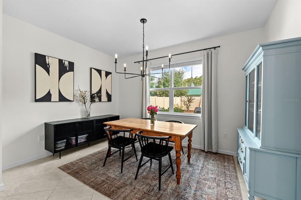 20402 Monza Loop Land O Lakes, FL 34638 - Photo 15 of 36 a dining room with a table chairs and a wooden floor