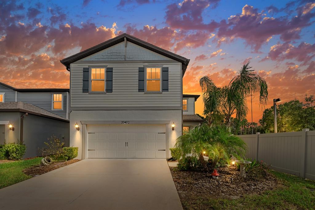 20402 Monza Loop Land O Lakes, FL 34638 - Photo 2 of 36 a front view of a house with a yard and garage