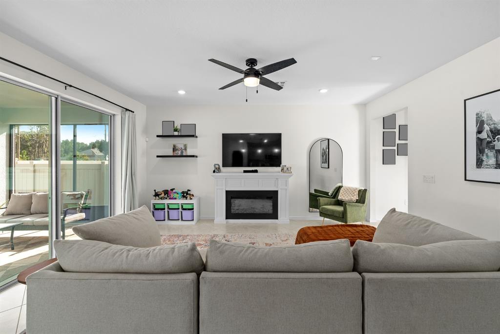 20402 Monza Loop Land O Lakes, FL 34638 - Photo 10 of 36 a living room with furniture and a fireplace