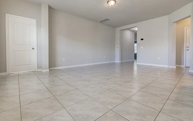 an empty room with cabinet and mirrors