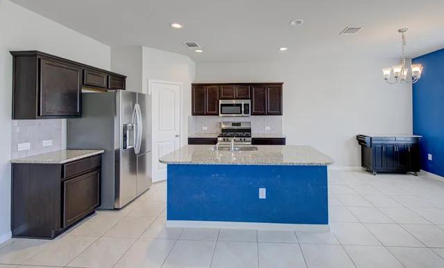 a kitchen with stainless steel appliances a refrigerator and a microwave