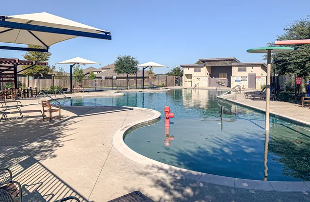 a view of a table and chairs under an umbrella