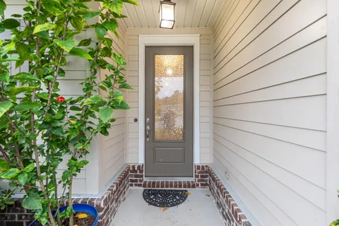 a view of a door and chair front of house