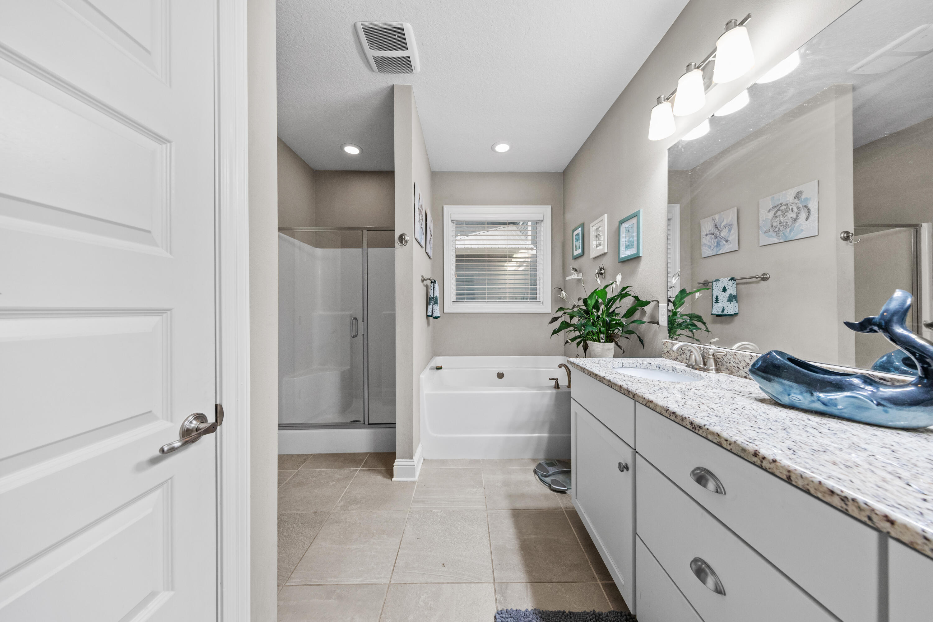 40 Oyster Boulevard Freeport, FL 32439 - Photo 15 of 30 a spacious bathroom with a granite countertop sink a toilet and shower