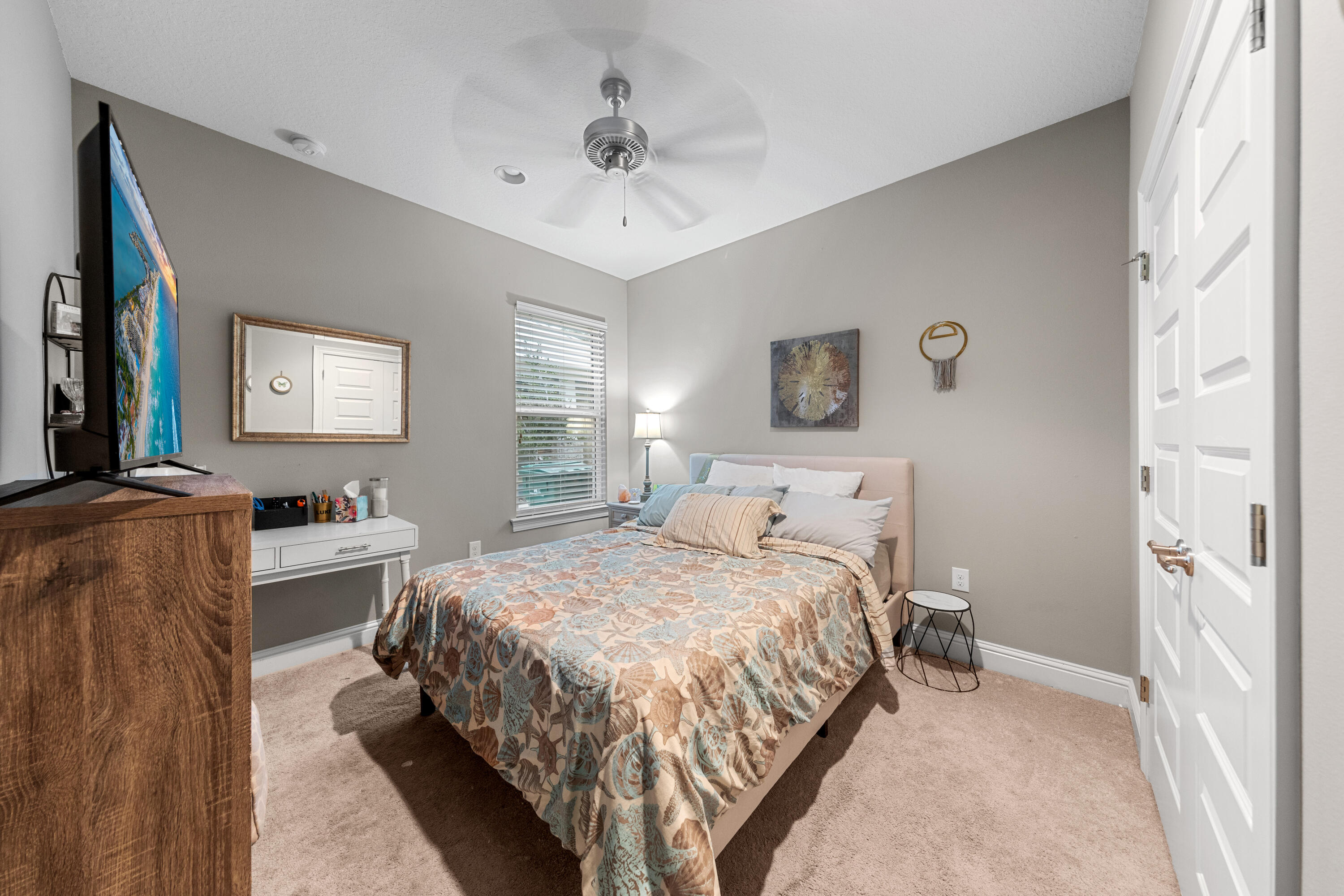 40 Oyster Boulevard Freeport, FL 32439 - Photo 22 of 30 a bedroom with a bed and a chandelier