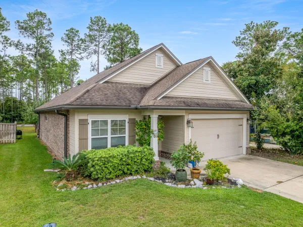 a front view of a house with a garden