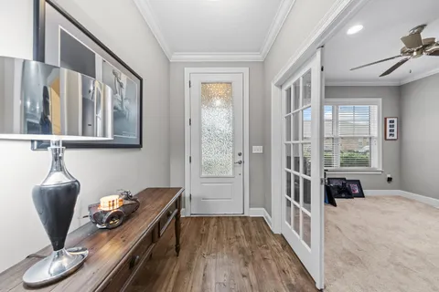 a hallway with a couch and a window
