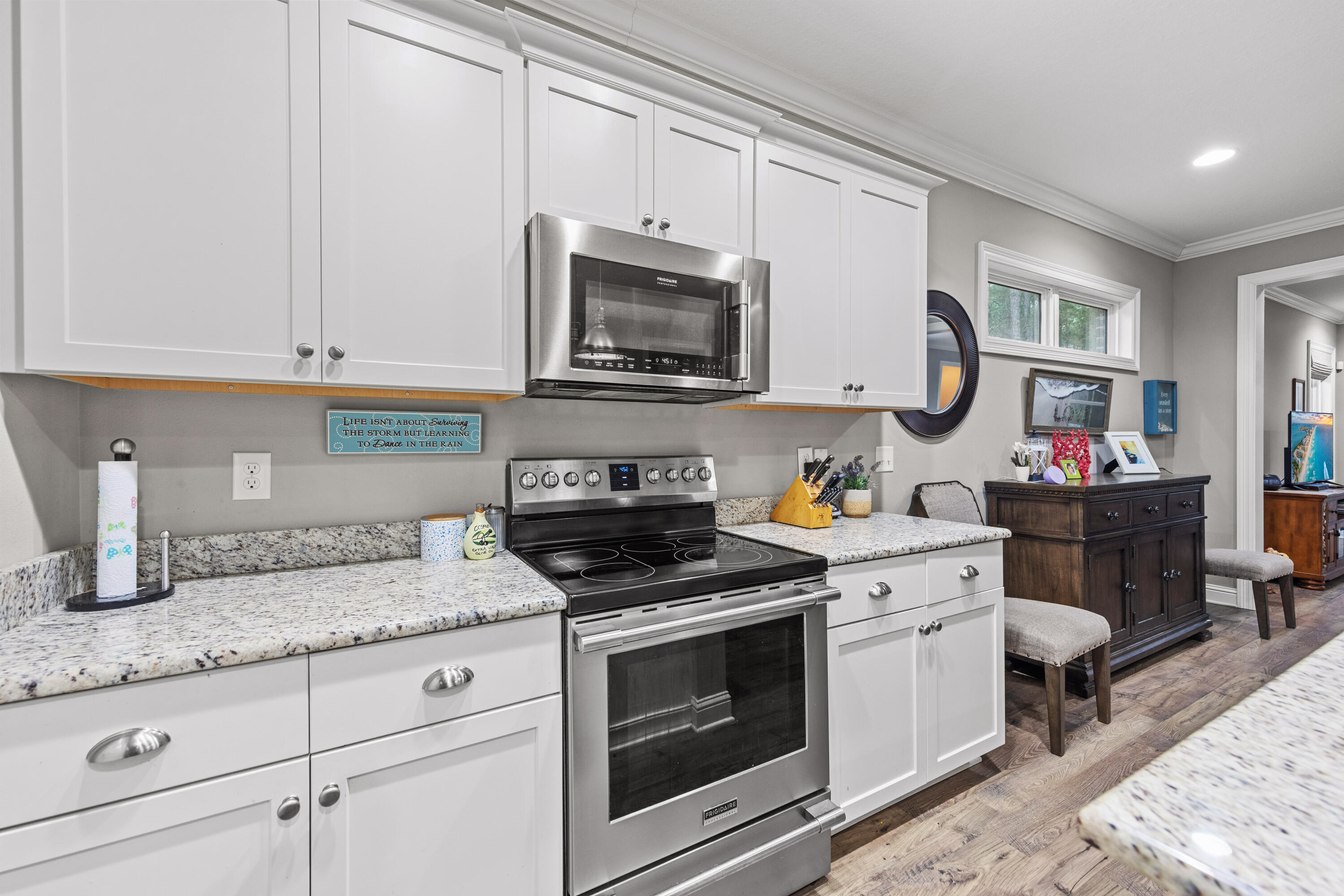 40 Oyster Boulevard Freeport, FL 32439 - Photo 8 of 30 a kitchen with granite countertop white cabinets and stainless steel appliances