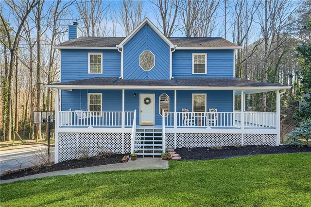a view of a house with a yard and a garden