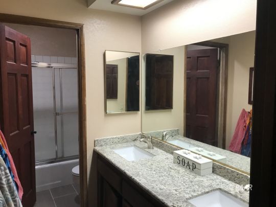 1009 Meadowview Lane Ridgecrest, CA 93555 - Photo 23 of 32 a bathroom with a granite countertop sink and a mirror