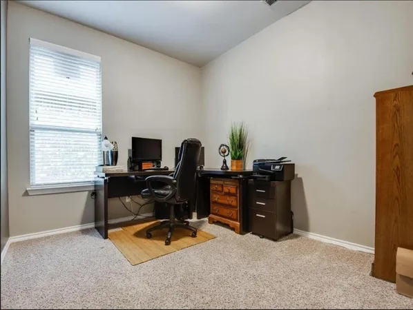 a view of workspace with furniture and windows